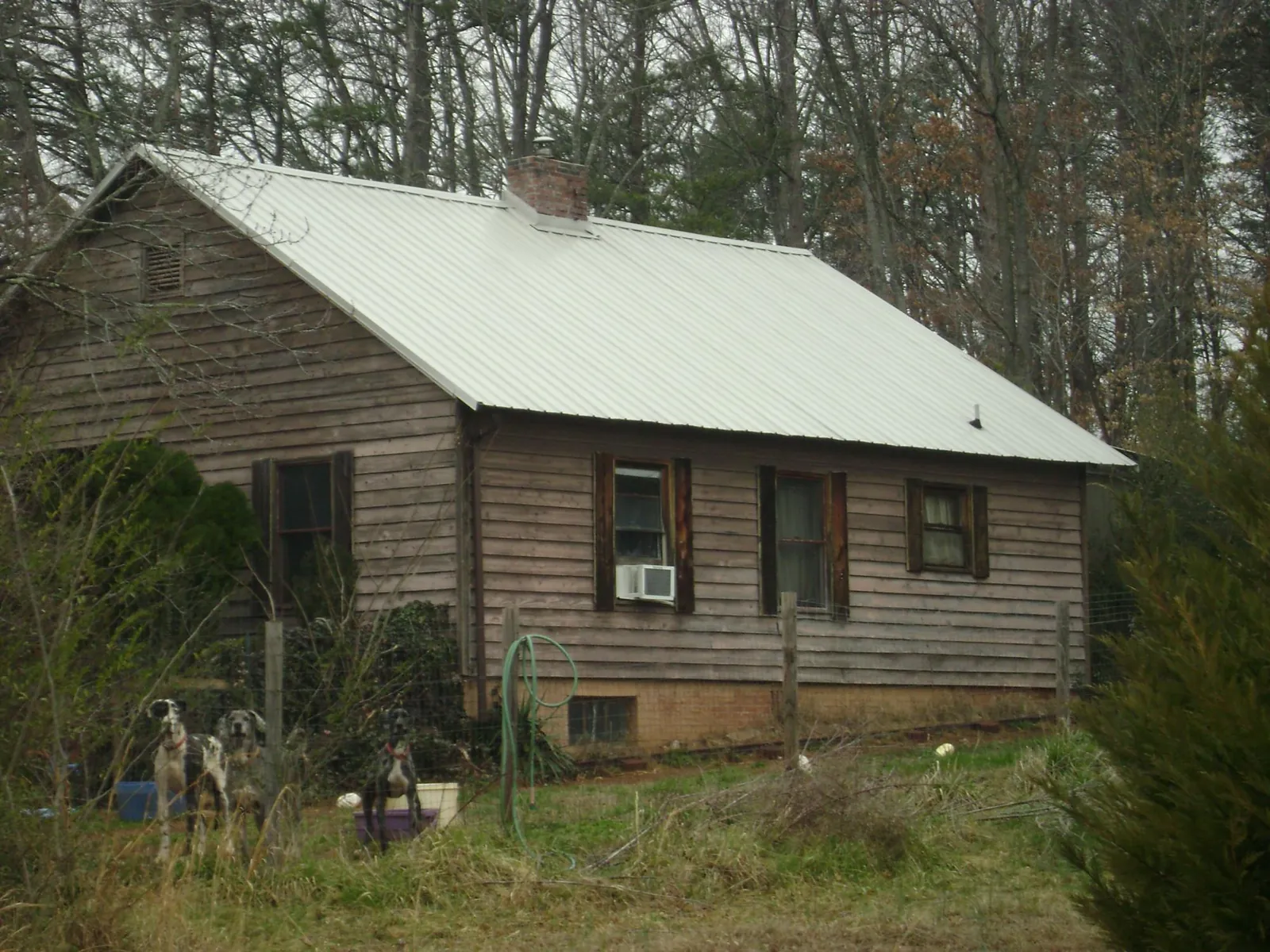 White metal roof on an old wood sided farmhouse, from a Metal Roof Installation job in Kings Park